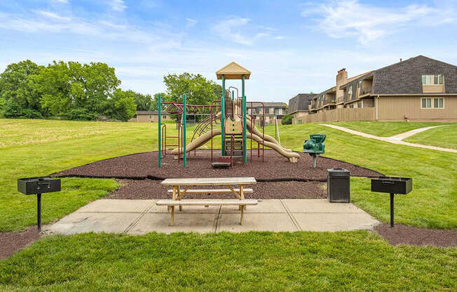 a park with a playground and a picnic table
