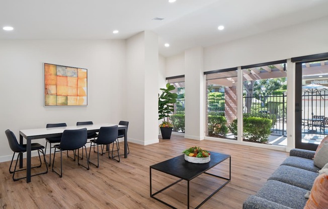 a dining room with a table and chairs and a large window