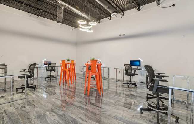 a large room with desks and chairs and a tv