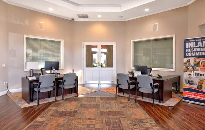 a room with a table and chairs with computers on top of it