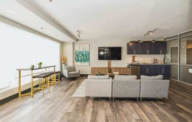 a living room with a couch and a table and a kitchen at The Lafayette Apartments, Colonial Place, Norfolk