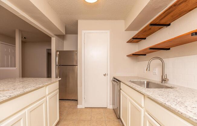 a kitchen with a sink and a mirror