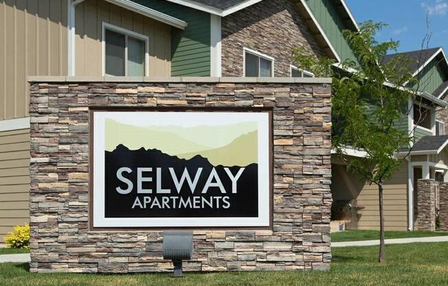 A sign for Selway Apartments is displayed in front of a building.