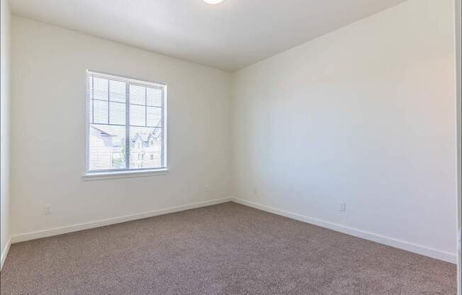 A room with a carpeted floor and a window at Riverplace Apartment Homes, Oregon, 97351