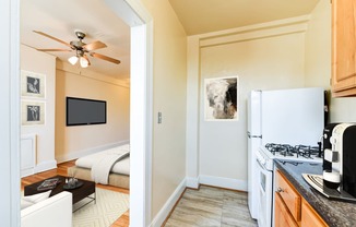 kitchen with gas range, wood cabinetry and energy efficient appliances at the foreland apartments in washinton dc