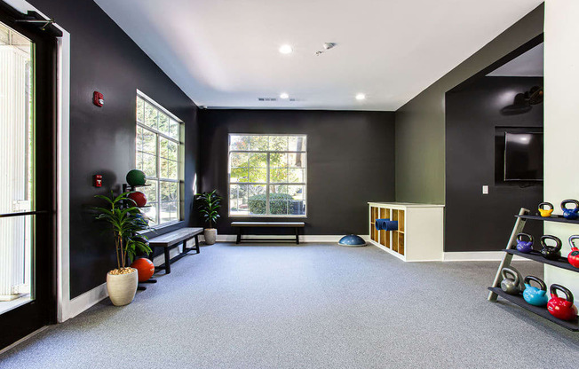 a yoga room with a large window and black walls