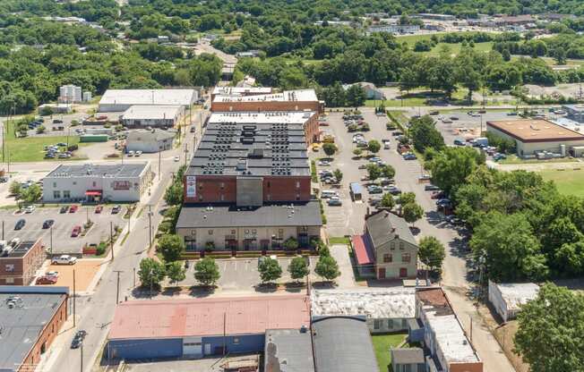 an aerial view of the parking lot and rooftops of buildings in a city