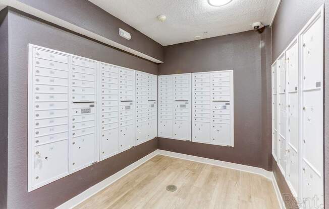 A room with a wall of lockers and a list of names on the wall.