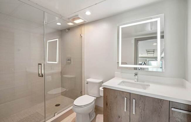 A modern bathroom with a toilet, sink, and shower. at The Mansfield at Miracle Mile, Los Angeles, CA, 90036