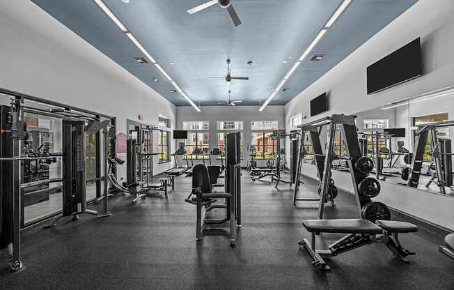 A gym with a variety of equipment including weights and machines.