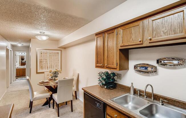 a kitchen with a sink and a dining room table