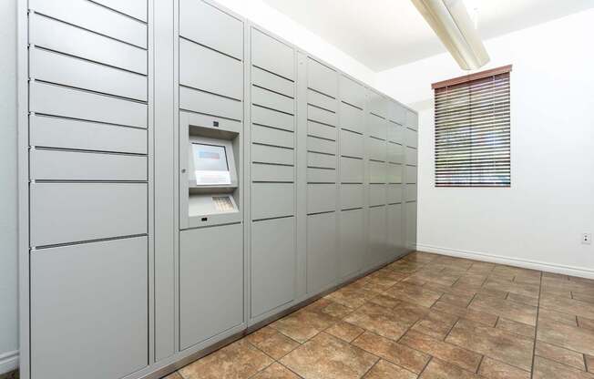 A row of grey lockers with a digital keypad on the doors.