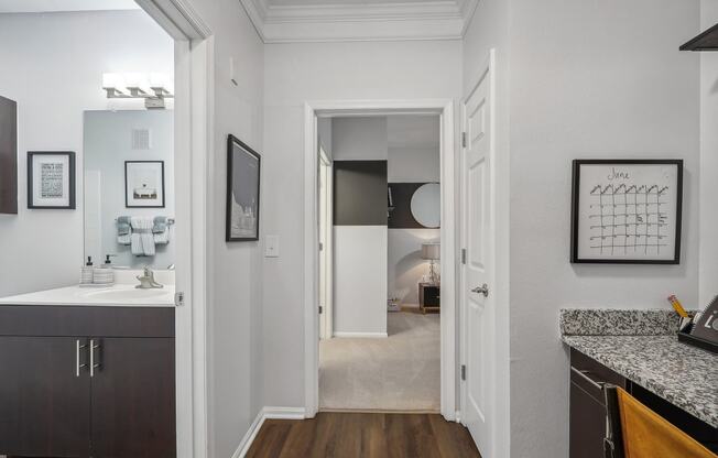 hallway leading to the bedroom with a bathroom and built-in desk