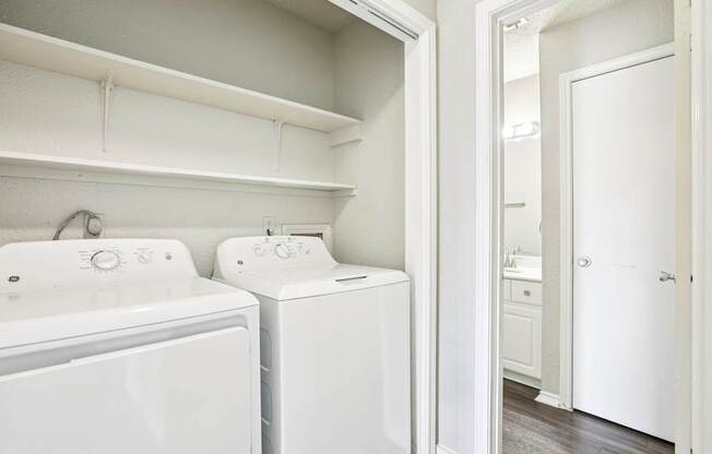 A white laundry room with a washer and dryer.