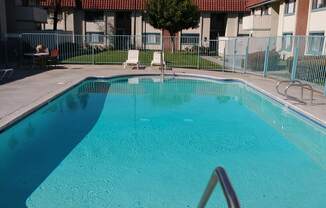 Inviting swimng pool and sun deck at Magnolia Apartments in Riverside, California.