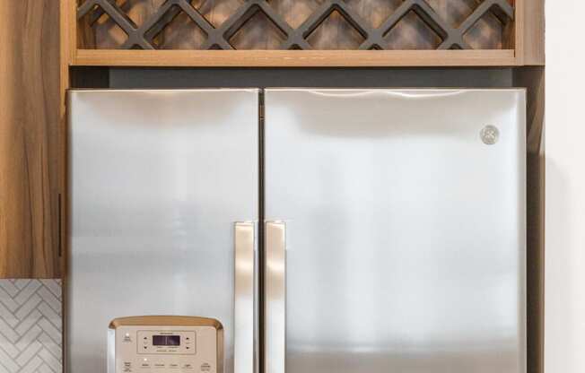 a kitchen with stainless steel appliances and a cabinet with a refrigerator at Dey & Bergen, Harrison, New Jersey