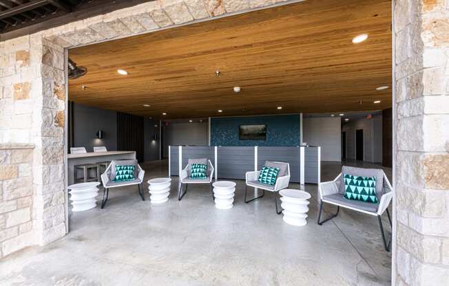 Lenox SoCo Apartments lounge area with chairs and tables and a wooden ceiling
