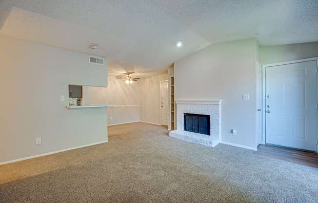 the living room of an empty house with a fireplace