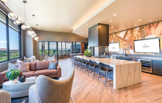 Host or unwind in the beautifully designed demonstration kitchen and lounge, featuring modern finishes, ample seating, and integrated entertainment displays.