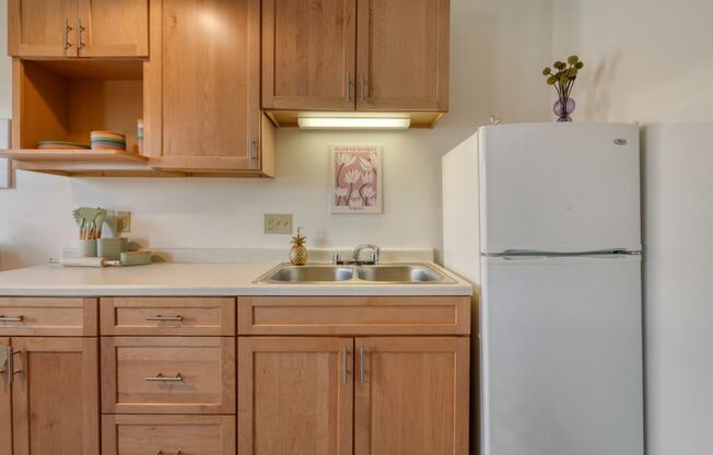 a kitchen with wooden cabinets and a white refrigerator