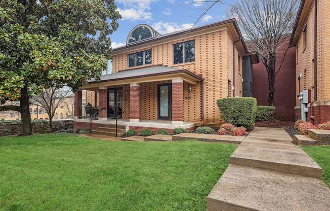 A house with a brick facade and a circular window on the top.