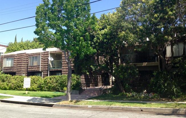 Street view of property with foliage