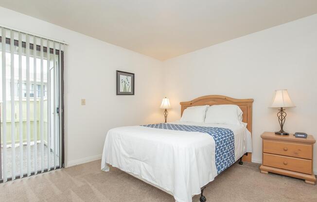 a bedroom with a bed and desk in a small room