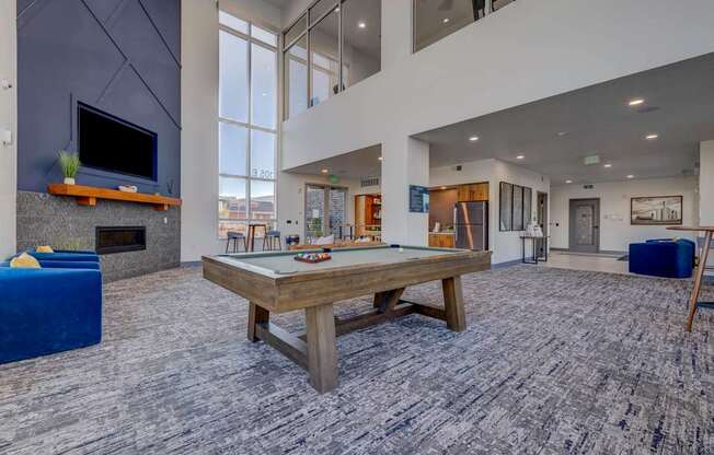 A large room with a fireplace and a television.