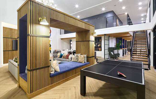 A room with a black table and a blue cushion.