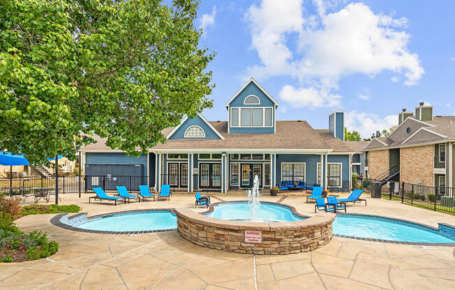 our apartments have a large pool and patio with chairs