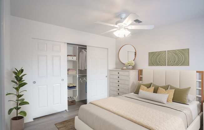 a bedroom with a bed and a ceiling fan