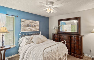 apartment bedroom with a ceiling fan