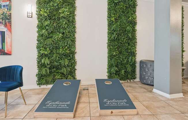 Two wooden boards with the word "Elysium" on them are in front of a green wall.