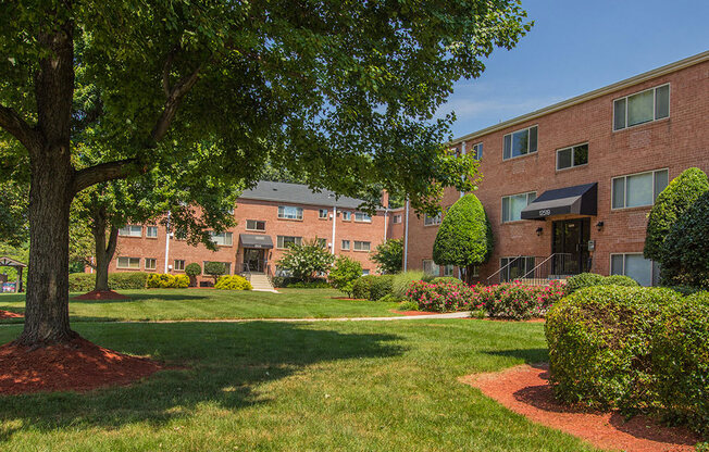 Exterior of apartment building with green landscaping at Woodlee Terrace Apartments, Virginia, 22192