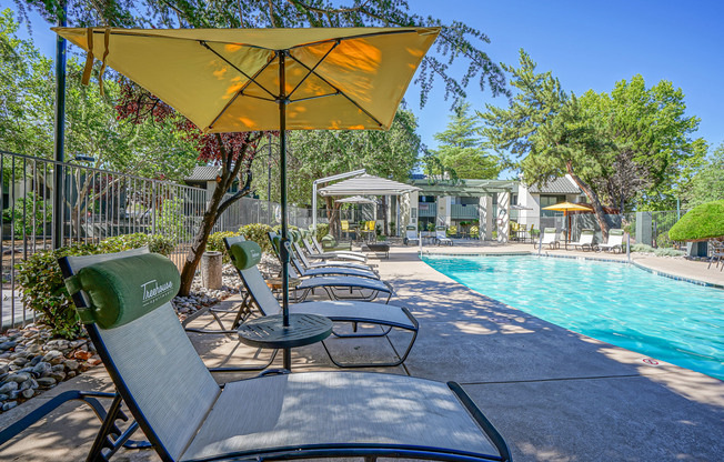 Poolside lounge with resort-style furniture at Treehouse Apartments in Albuquerque, New Mexico