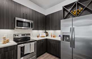 a kitchen with stainless steel appliances and brown cabinets