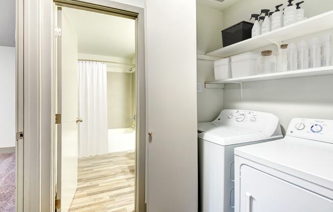 a white washer and dryer in a white laundry room