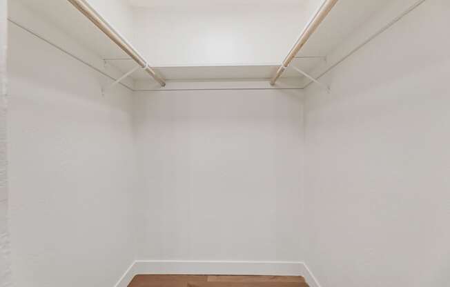 A white room with a wooden floor and a white ceiling.