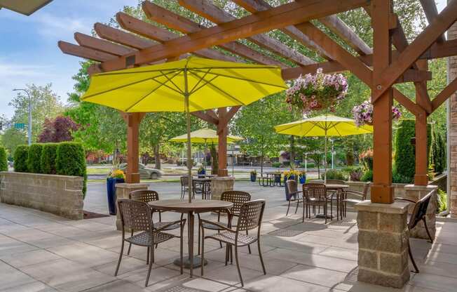 a patio with tables and chairs and umbrellas at Delano, Redmond