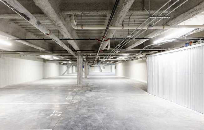 A large, empty parking garage with concrete floors and walls.