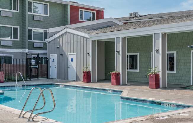a swimming pool in front of a building with a pool