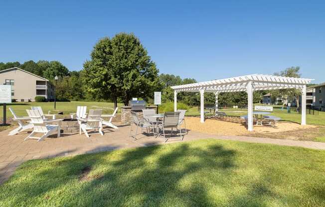 a patio with tables and chairs and a white canopy