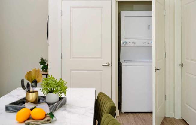 a kitchen and dining room with white appliances and a table