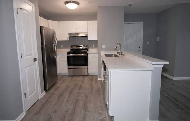 A kitchen with a refrigerator, oven, and sink. at Evergreen, Indiana, 46410