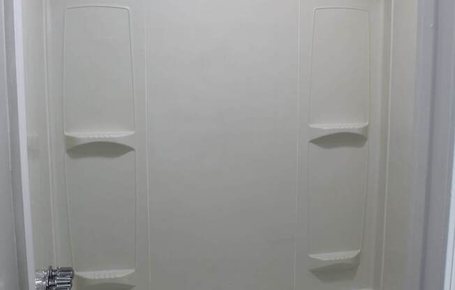A white bathroom with a toilet and a bathtub.
