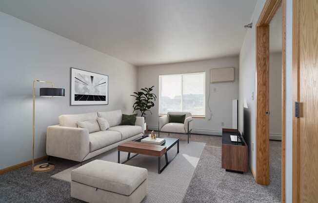 a living room with a white couch and a coffee table. Grand Forks Desoto Estates