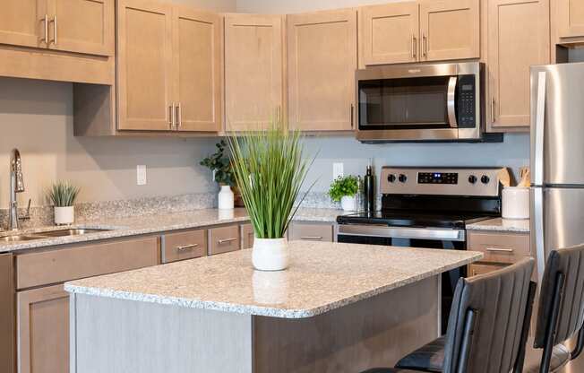 a kitchen with a large island and stainless steel appliances