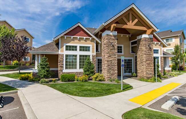 entry way with a sidewalk and green grass at Quail Springs Apartments