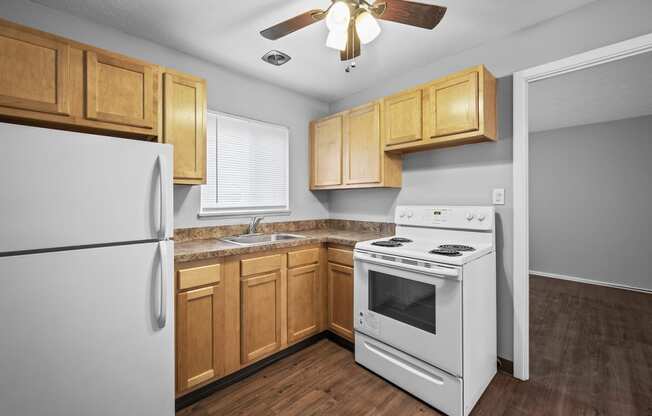 a kitchen with white appliances and wooden cabinets