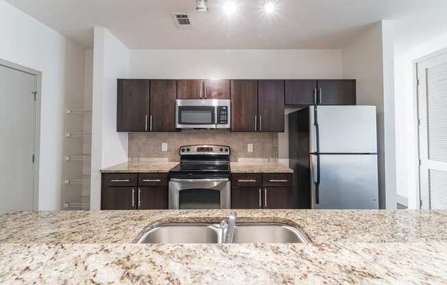 a kitchen with granite counter tops and stainless steel appliances